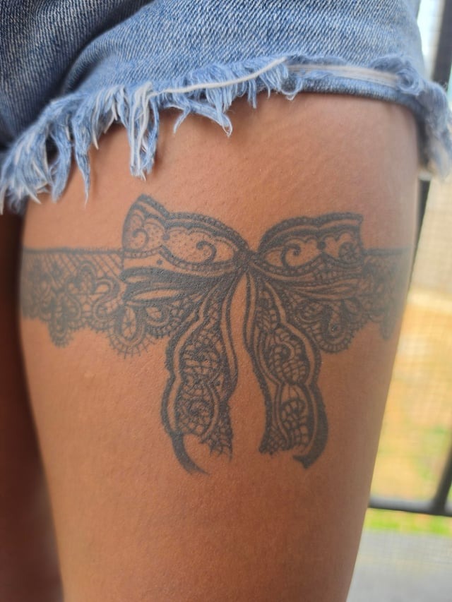 Intricate Lace Garter Thigh Tattoo