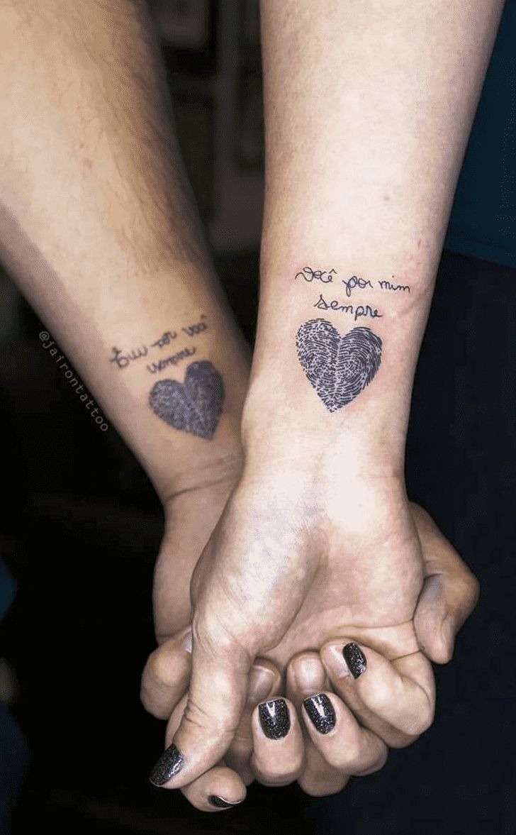 Heart-shaped thumbprint tattoos for couples