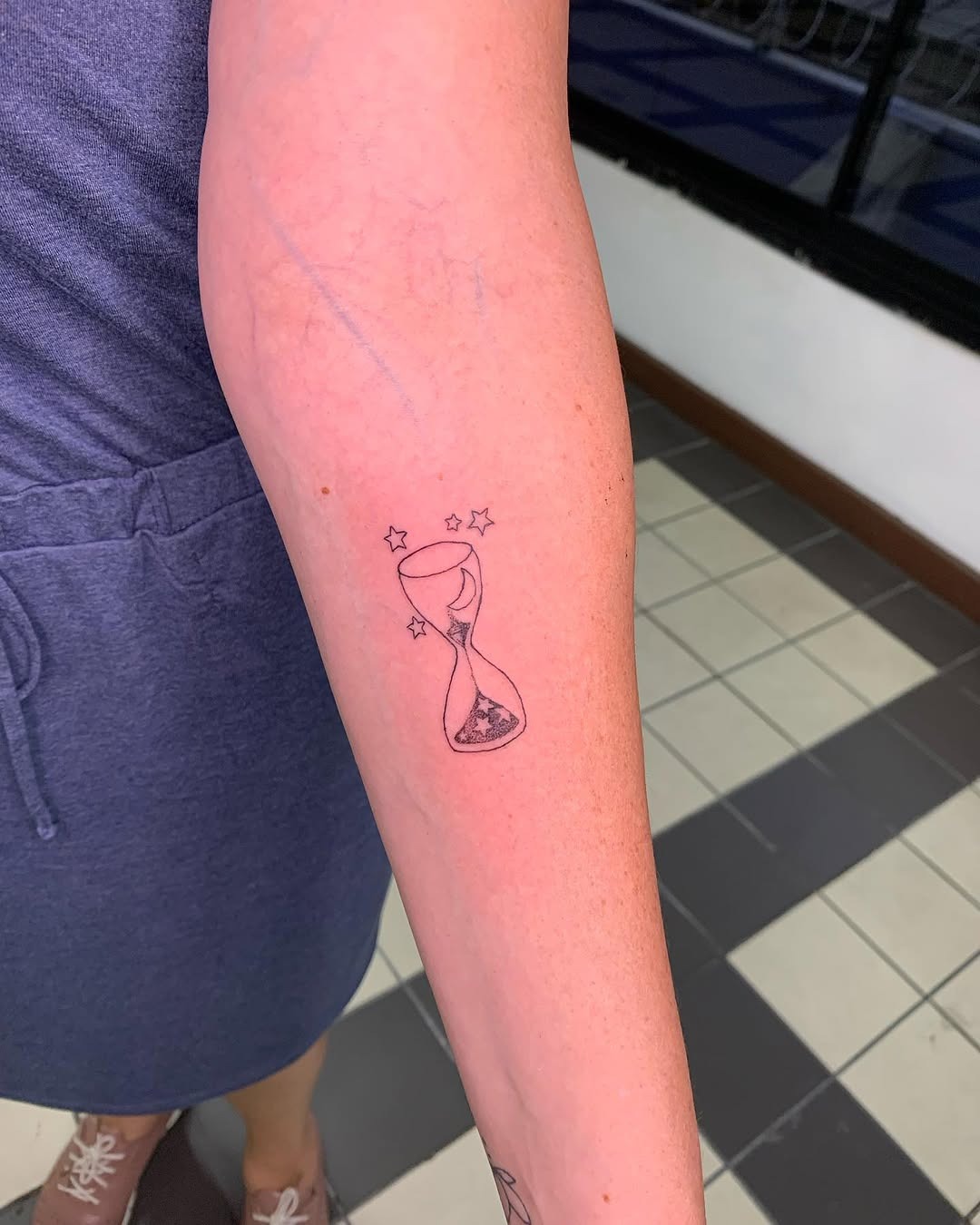 Minimalist celestial hourglass tattoo