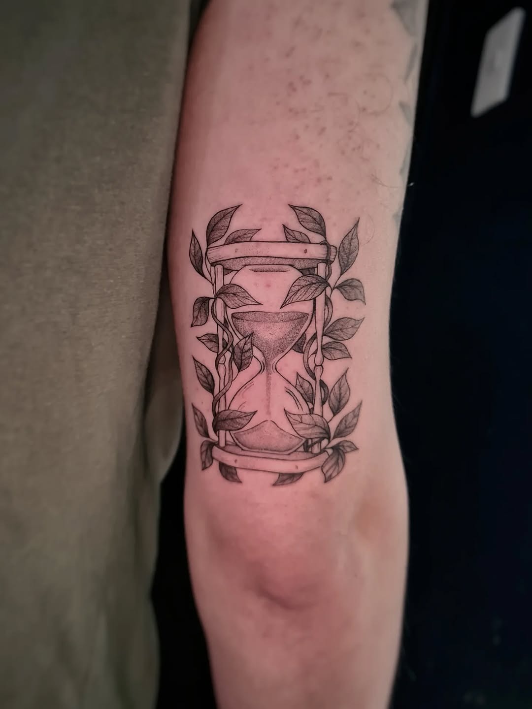 Delicate botanical hourglass arm tattoo
