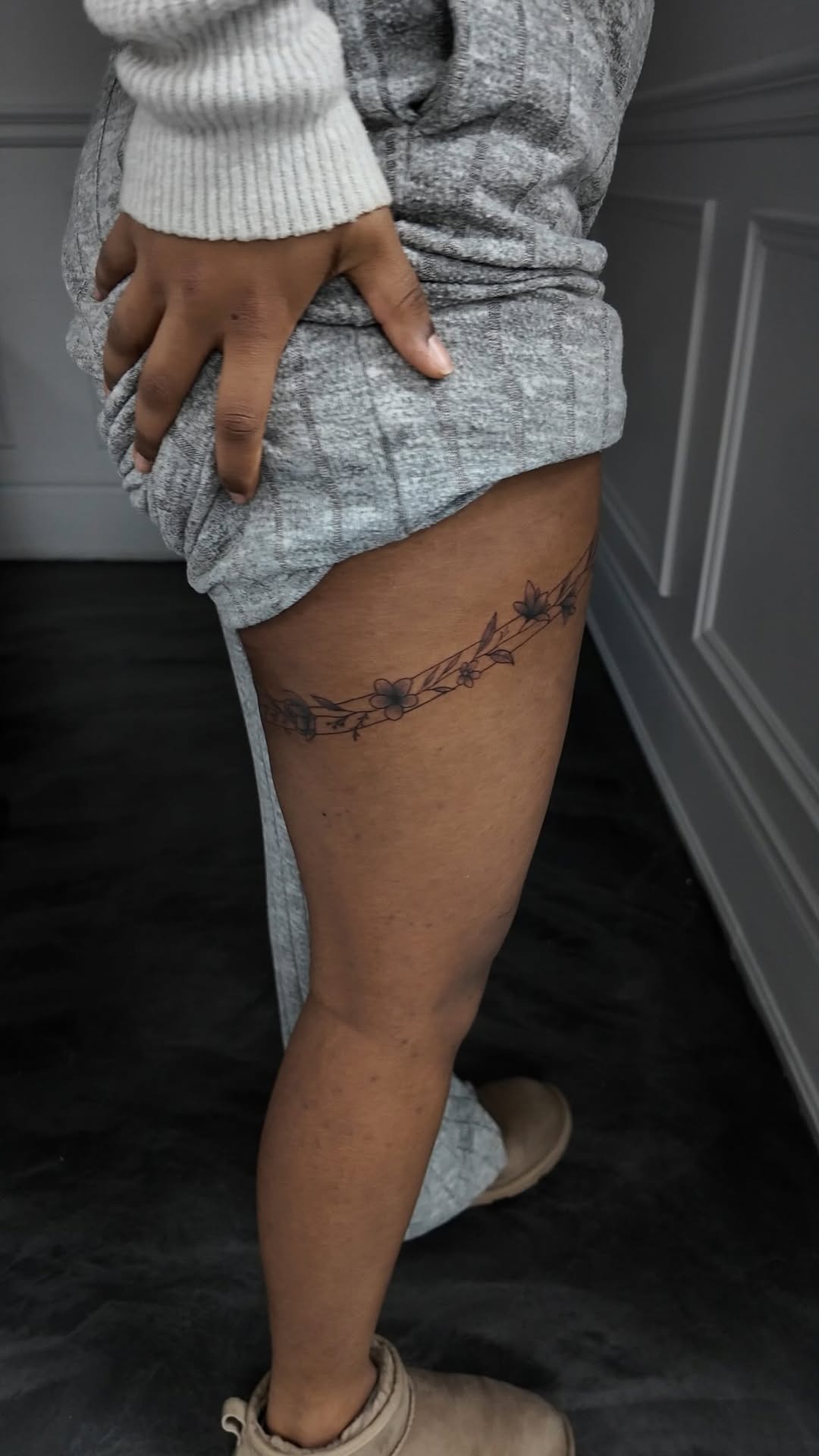 Delicate vine and floral thigh band tattoo