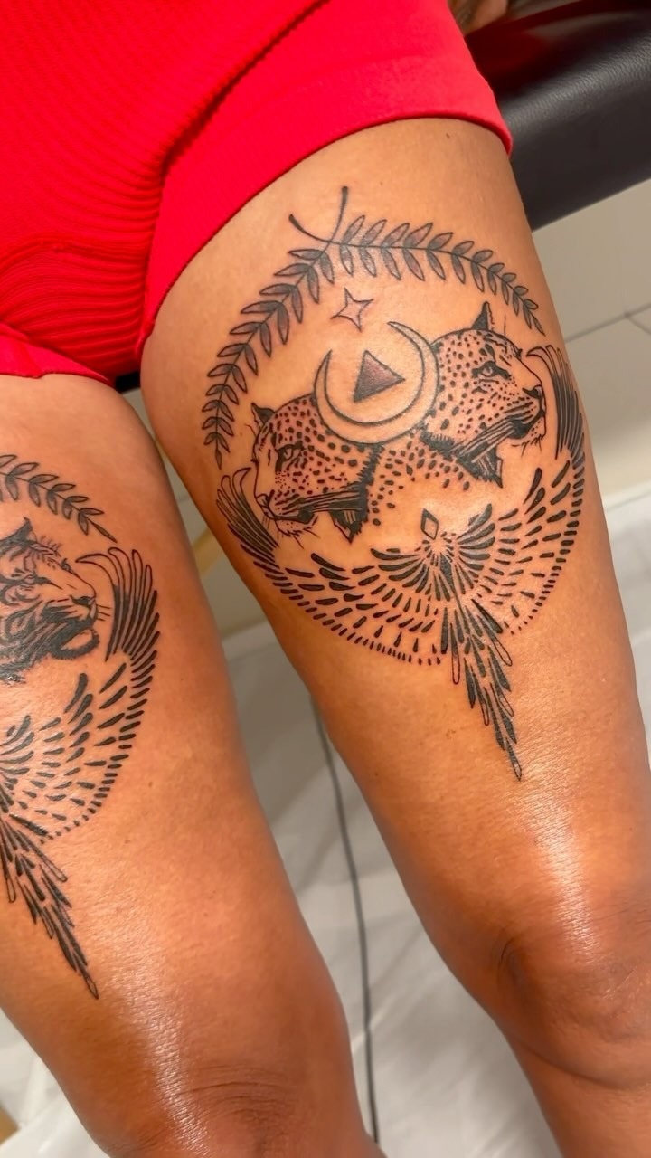 Intricate sacred symbol thigh tattoo