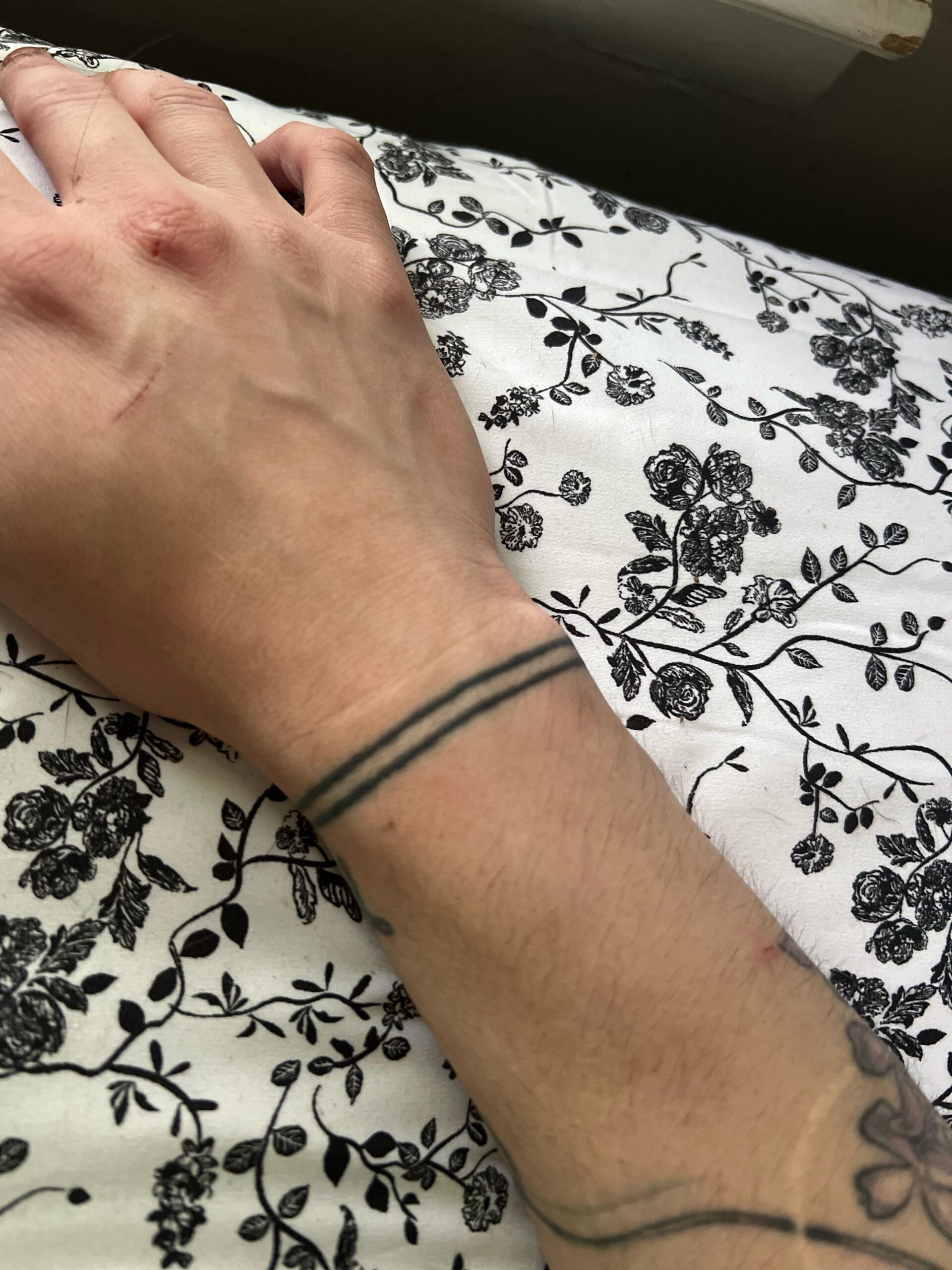 Clean double-line wrist band tattoo