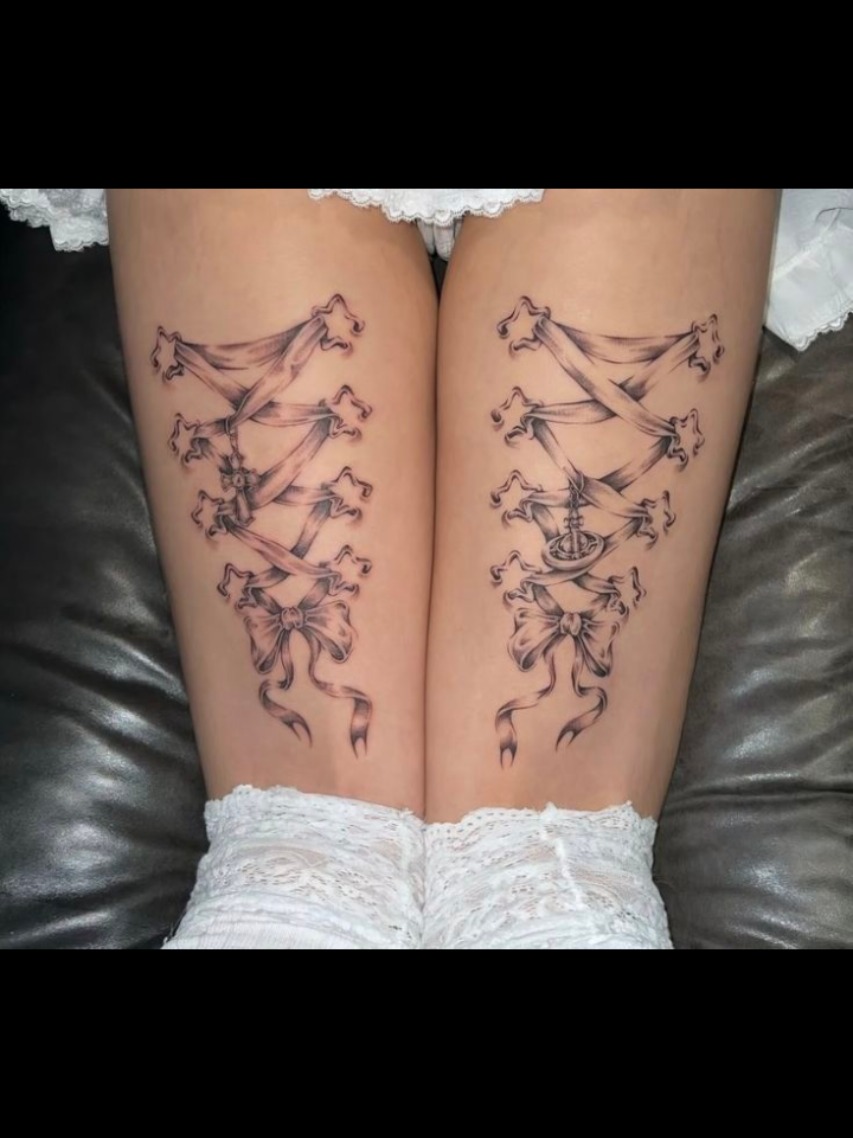Intricate Corset-Inspired Lace Thigh Tattoos
