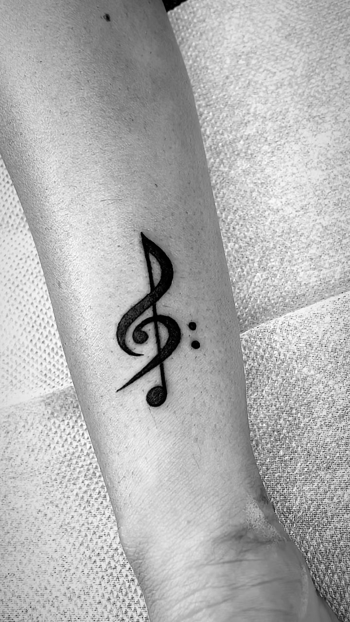 Elegant Treble Clef Forearm Tattoo