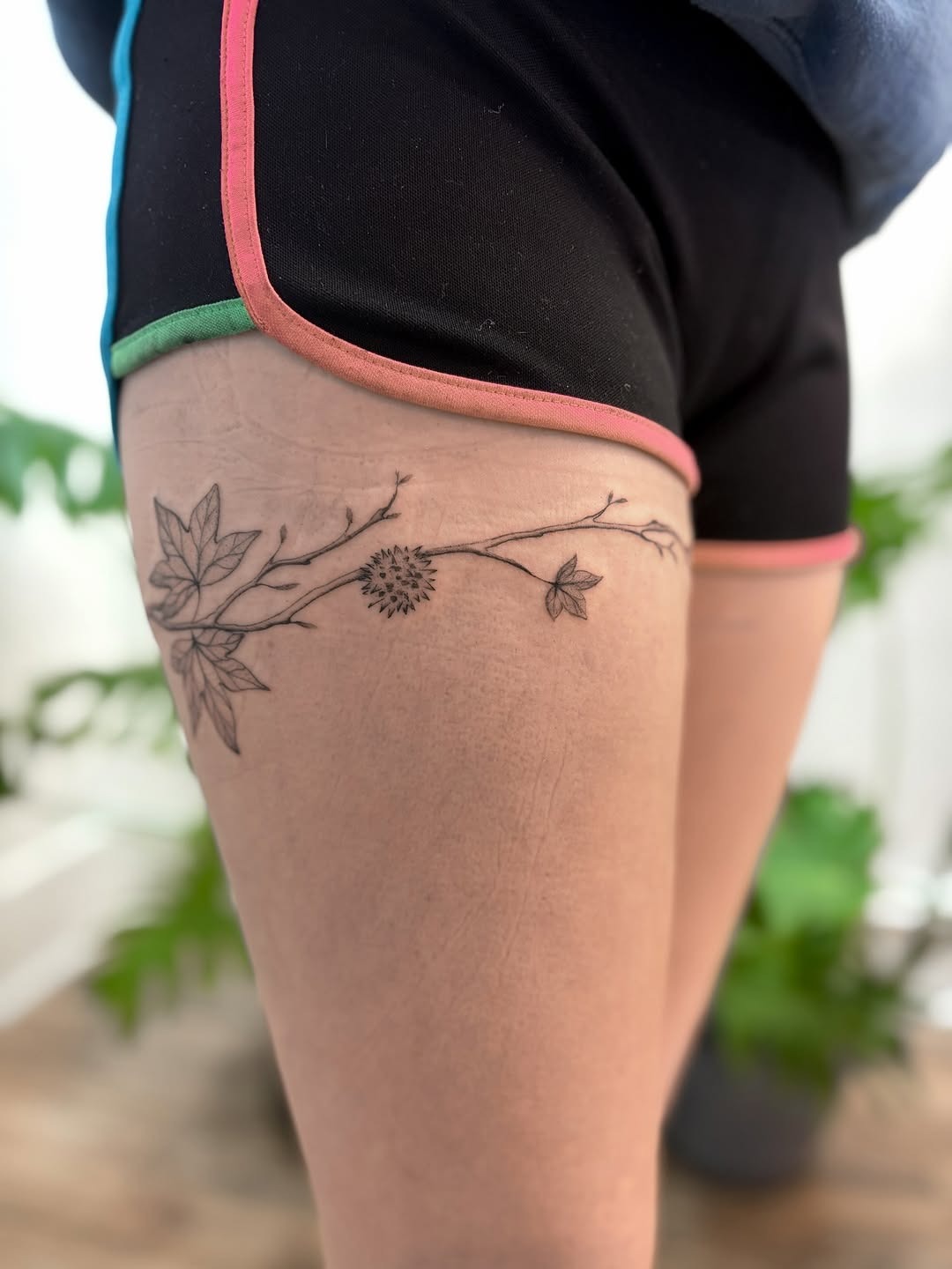 Delicate minimalist thigh tattoo