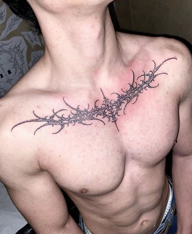 Minimalist ornamental chest tattoo
