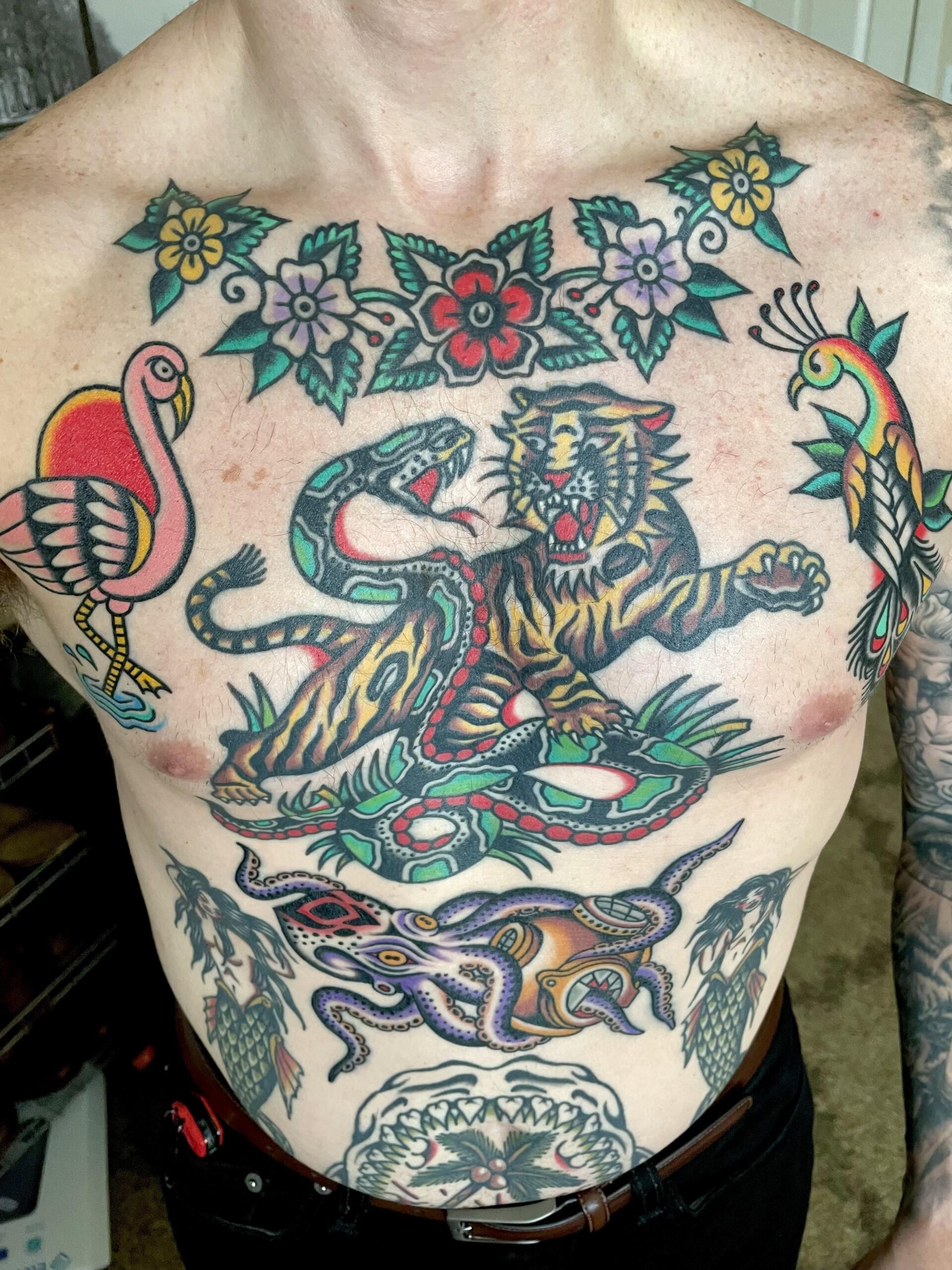 Bold traditional tiger and snake chest tattoo