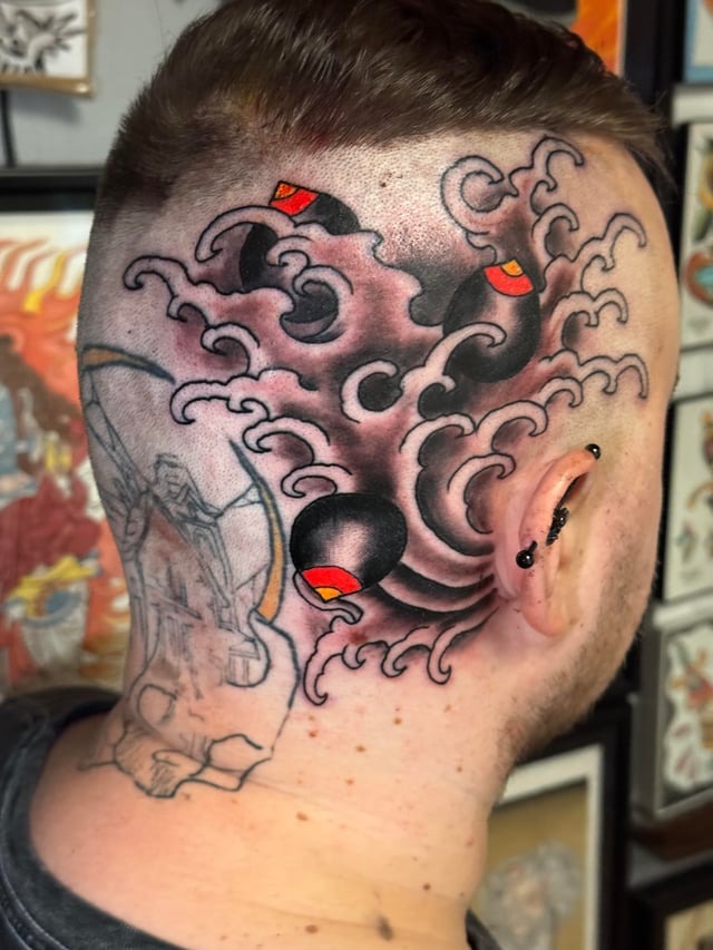 Bold Japanese style head tattoo with wave details