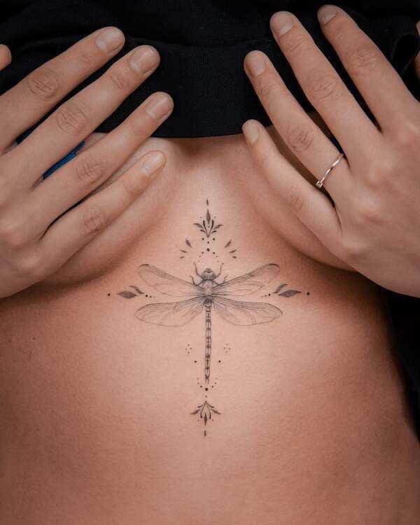 Delicate dragonfly sternum tattoo placement