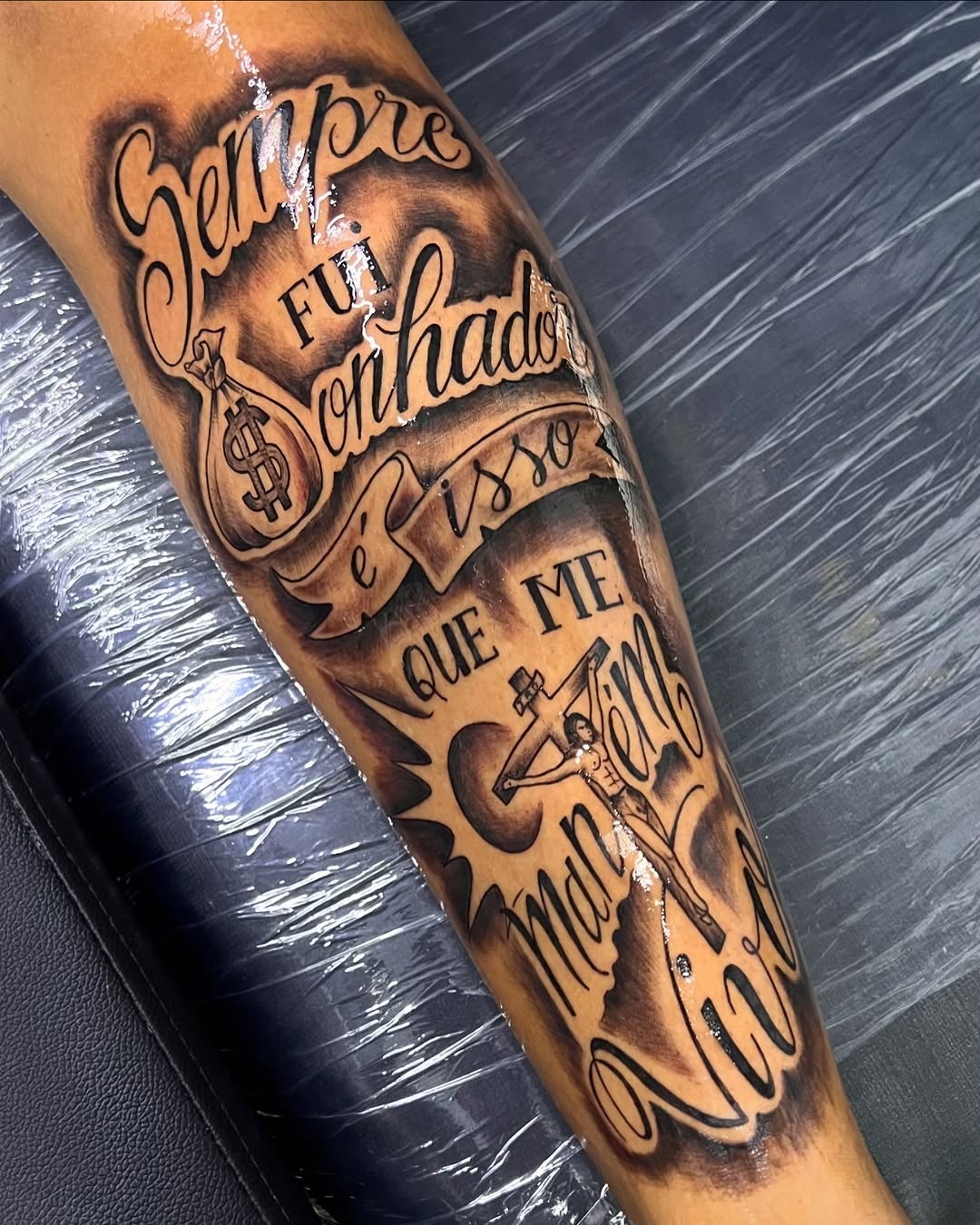 Detailed religious lettering calf tattoo