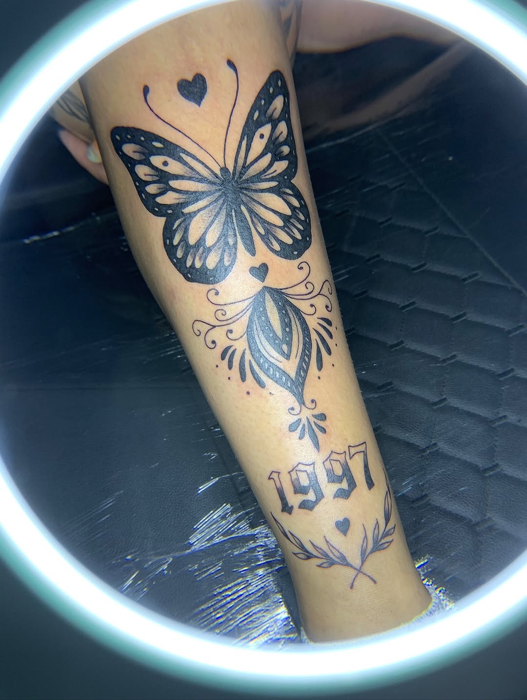 Delicate butterfly shin tattoo