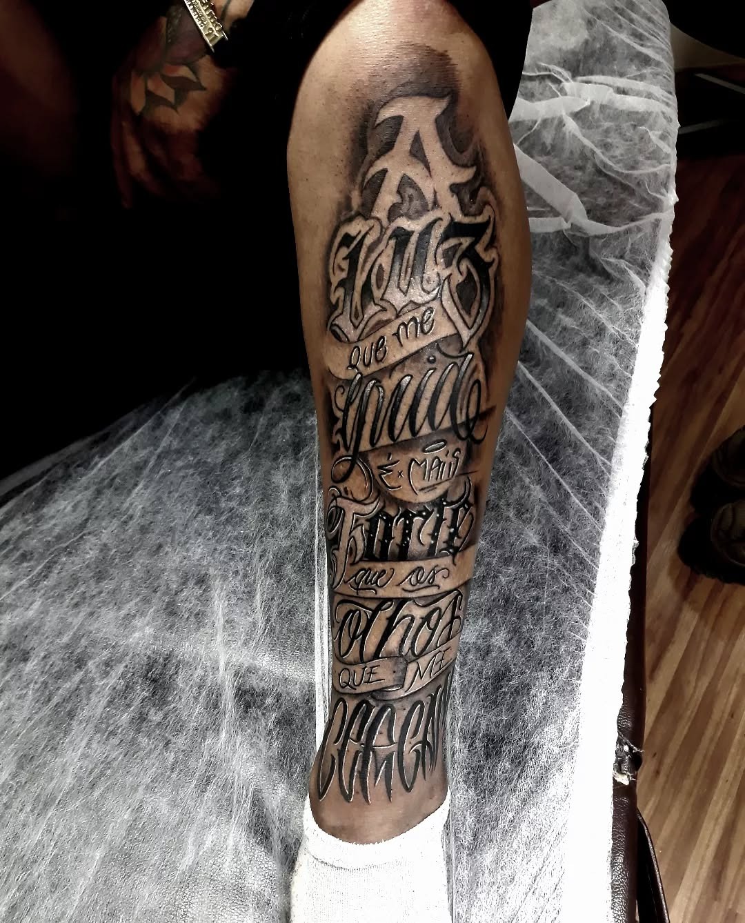Bold typography shin tattoo