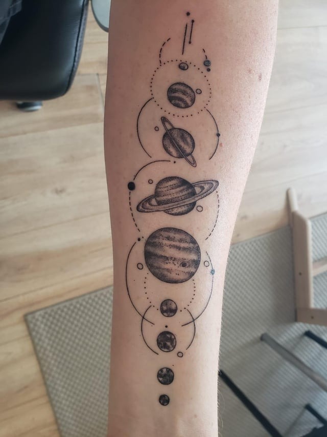 Intricate Dot-Work Planetary Tattoo