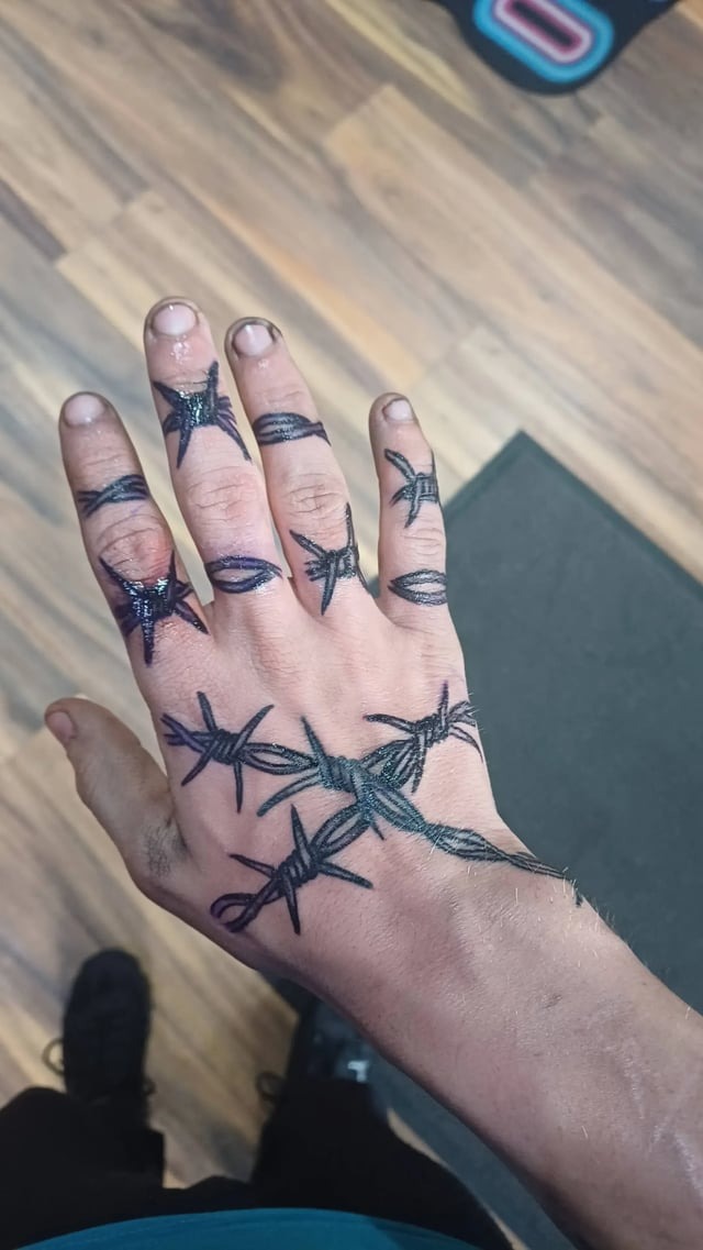 Edgy Barbed Wire Hand Tattoo