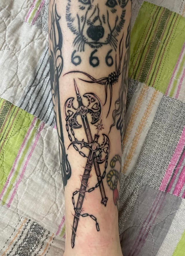 Intricate Barbed Wire and Weapon Tattoo