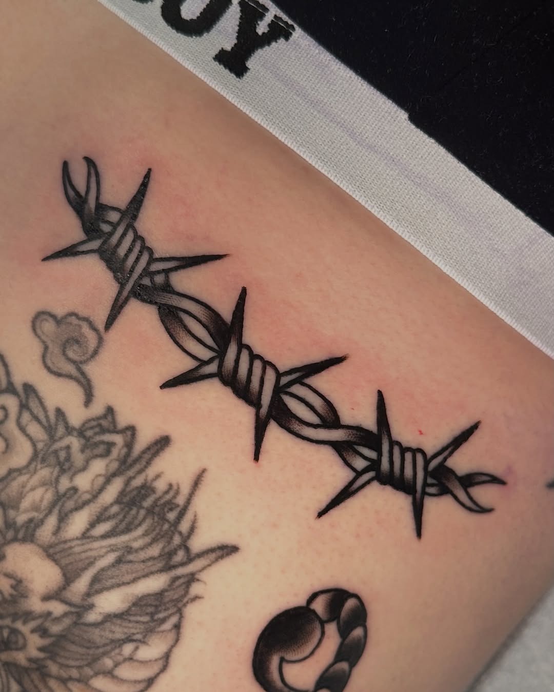 Bold Barbed Wire Tattoo Detailing