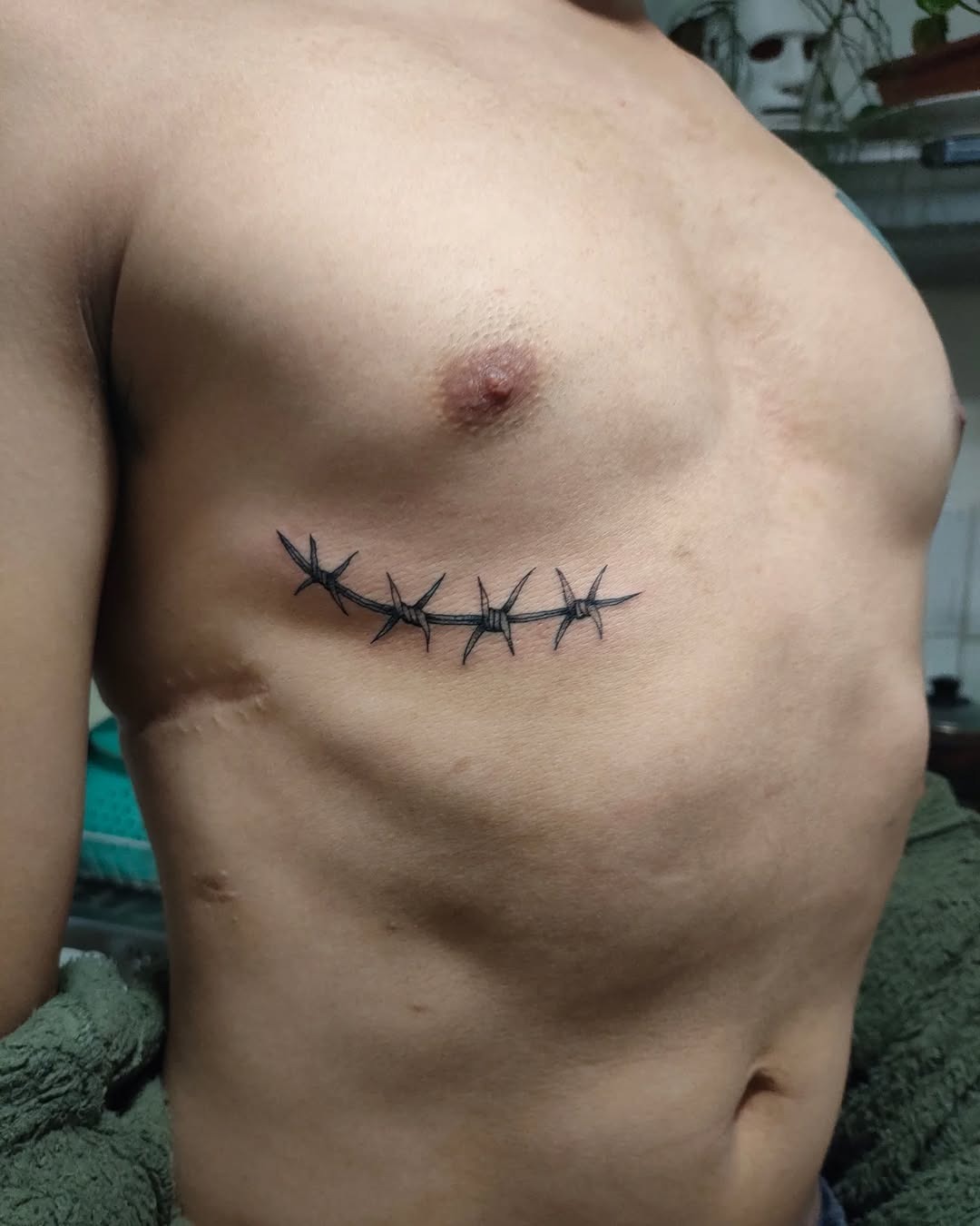 Subtle Rib Cage Barbed Wire Tattoos