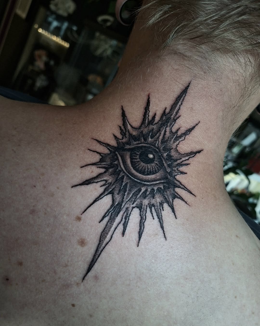 Edgy Spiked Eye Neck Tattoo