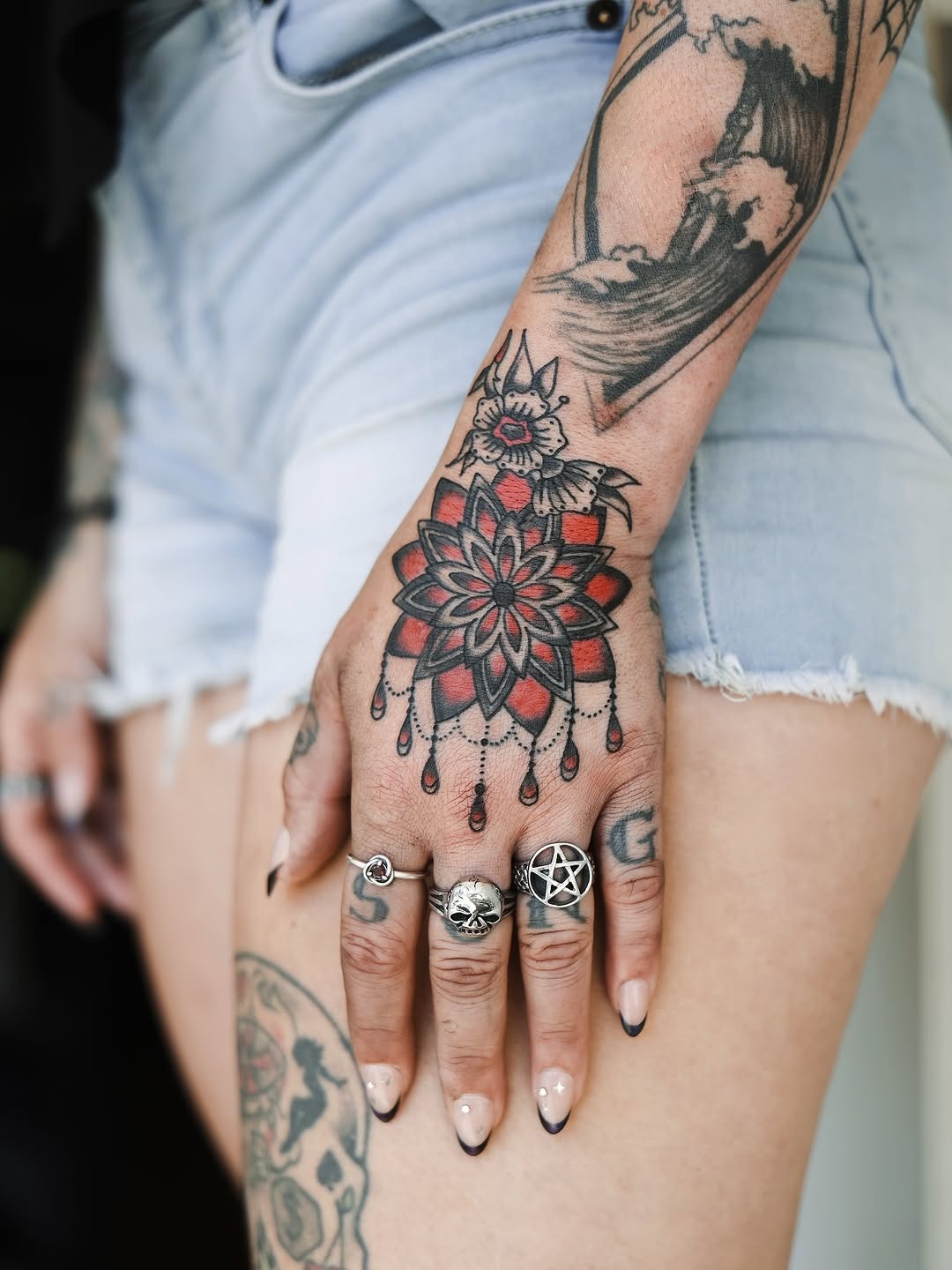 Vibrant Red Mandala Hand Tattoo