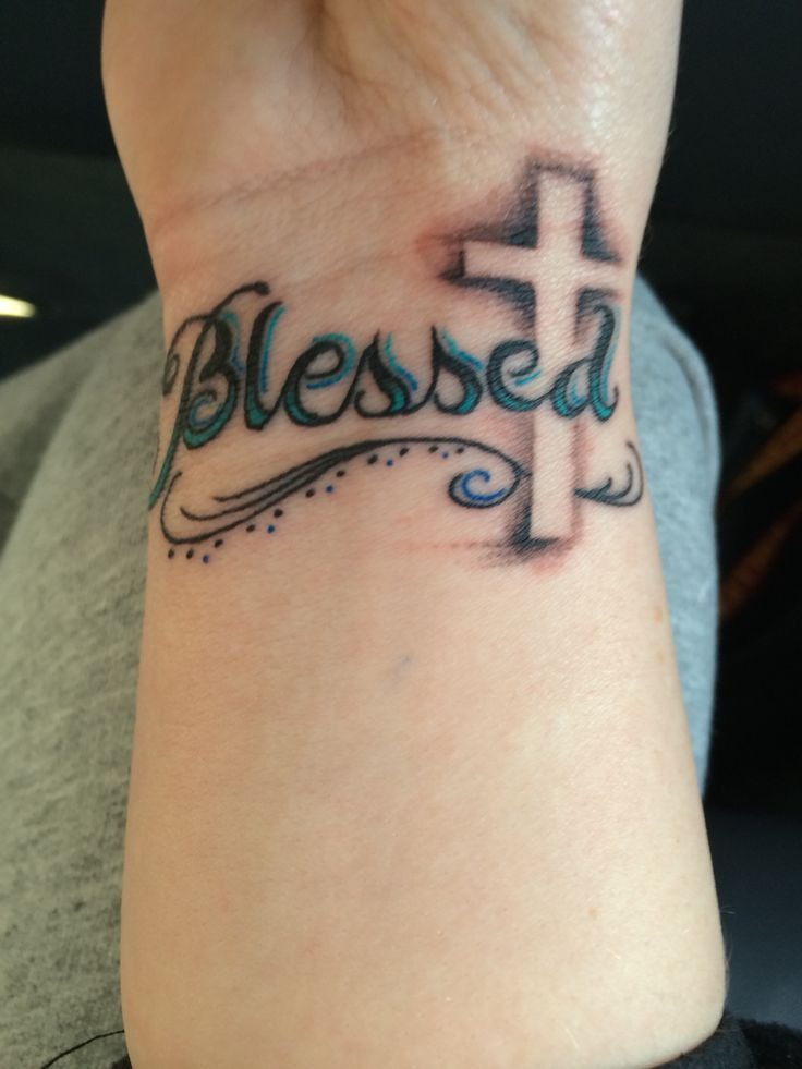 Minimalist cross and blessed wrist tattoo
