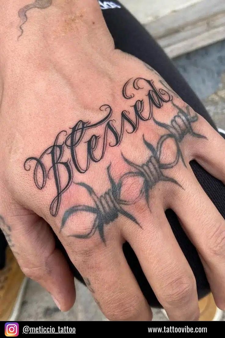 Edgy blessed hand tattoo with barbed wire motif