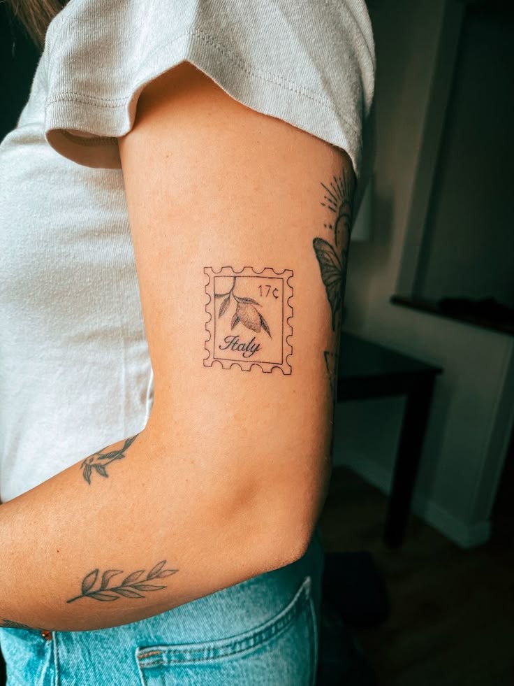 Dainty Italian travel postage stamp tattoo