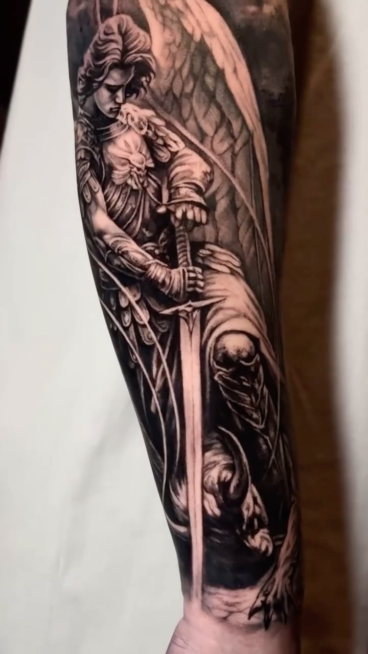 Intricate religious angel sleeve tattoo