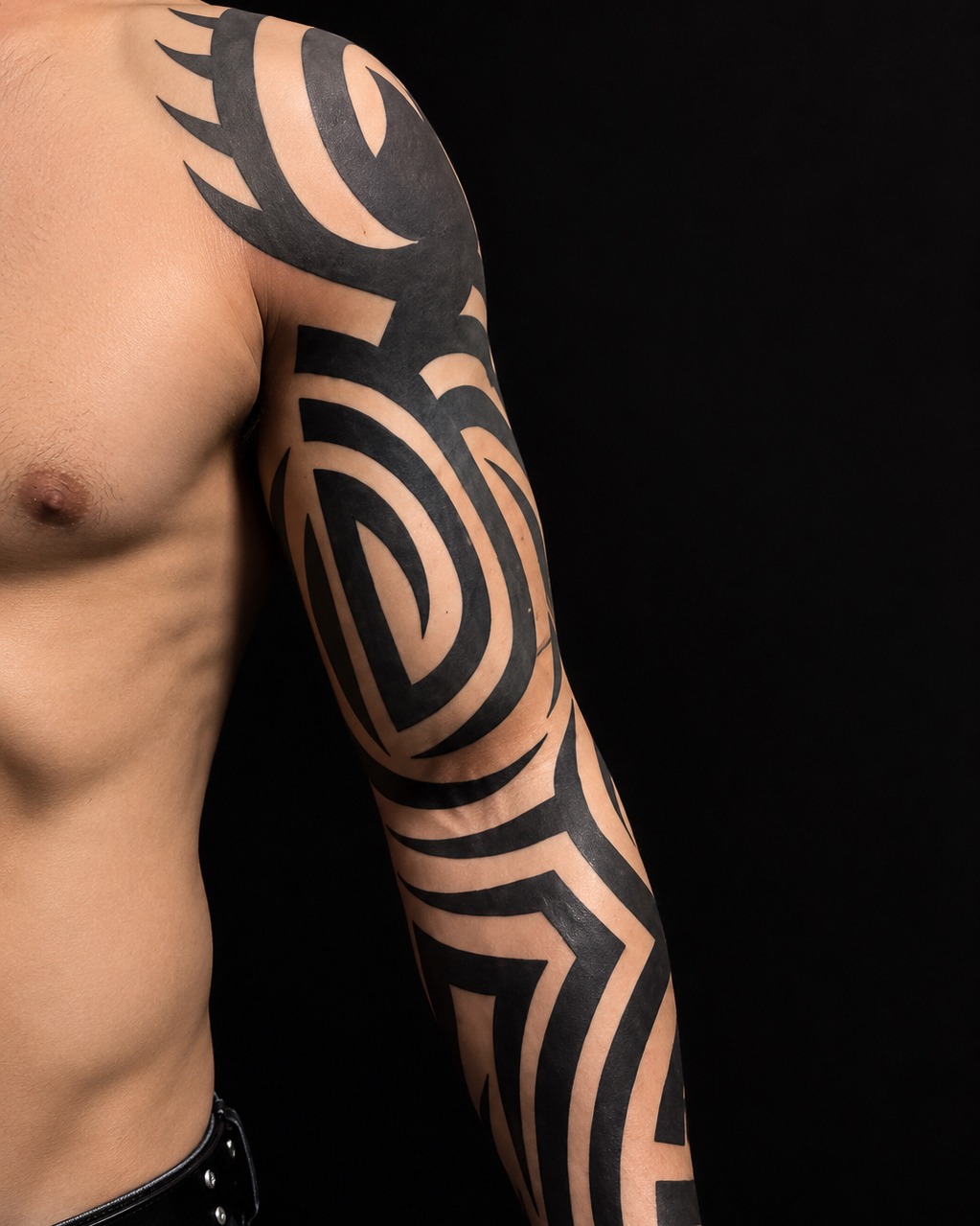 Bold geometric tribal arm tattoo