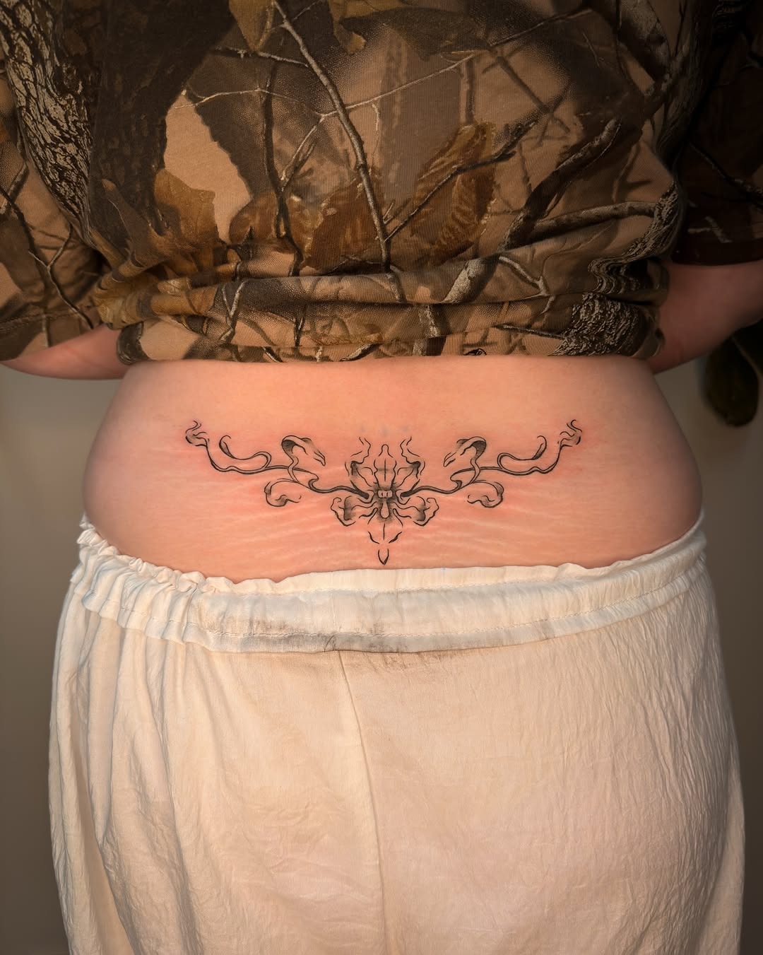 Delicate Ornamental Lower Back Tattoo
