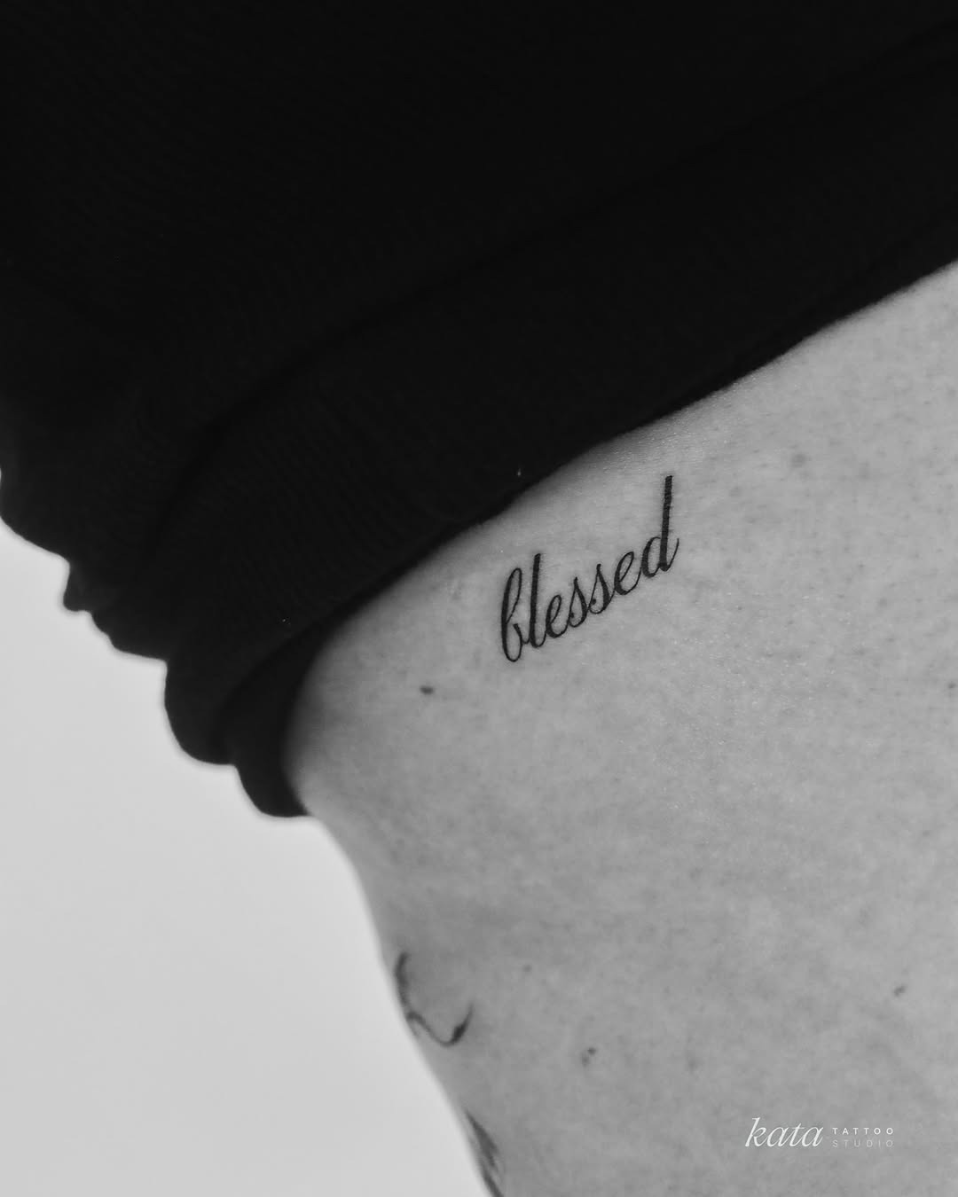 Minimalist 'Blessed' Script Tattoo