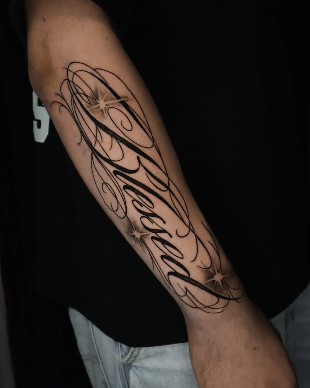 Intricate hand-lettered 'Blessed' forearm tattoo