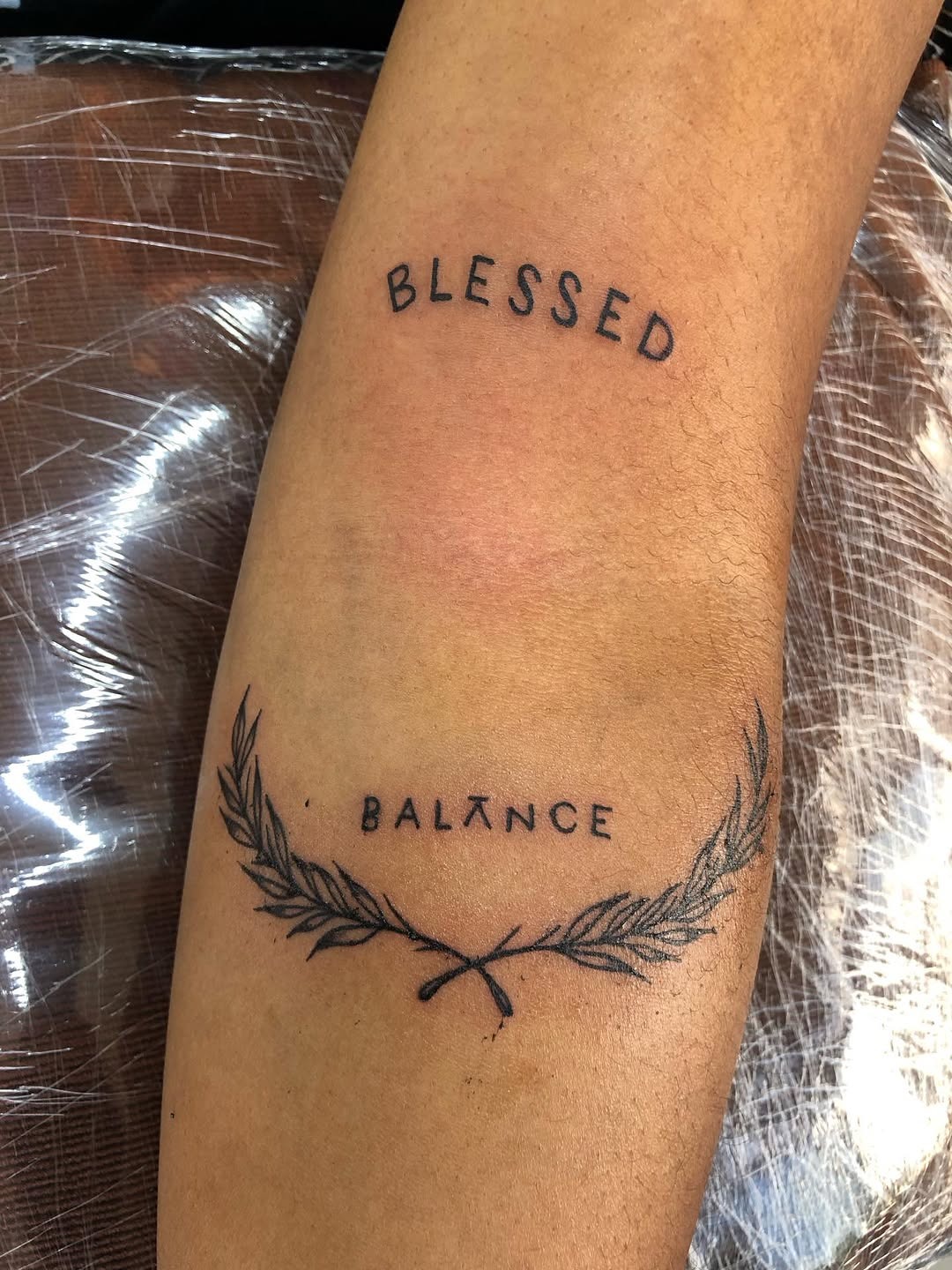 Minimalist 'Blessed' forearm tattoo design