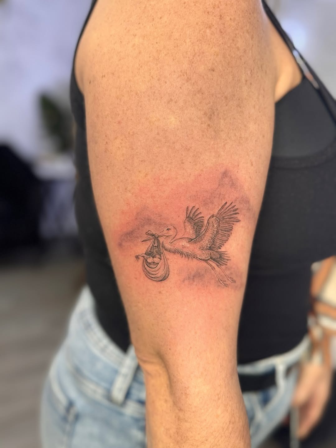 Delicate stork symbol tattoo