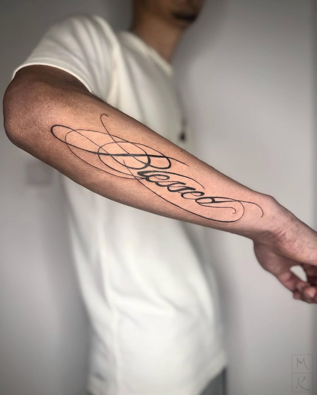 Minimalist Blessed script forearm tattoo