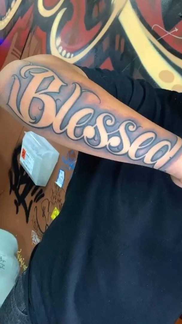 Bold Forearm Blessed Script Tattoo