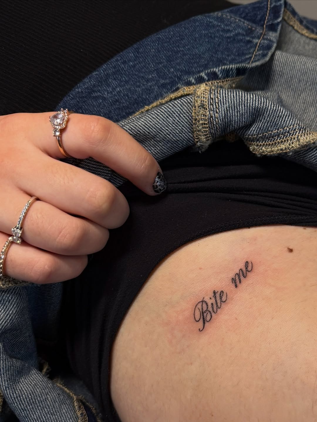 Dainty 'Bite Me' Script Tattoo