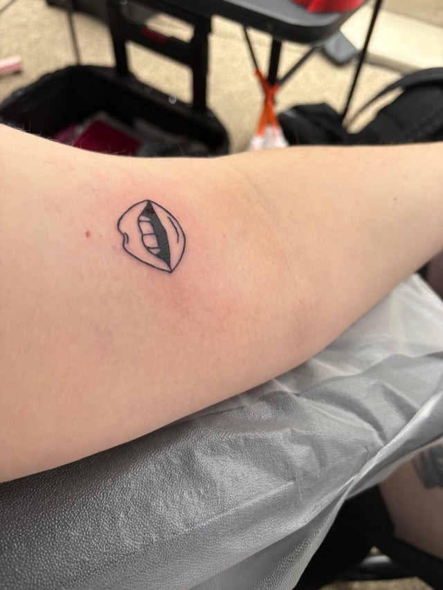Minimalist bitten lip fine-line tattoo