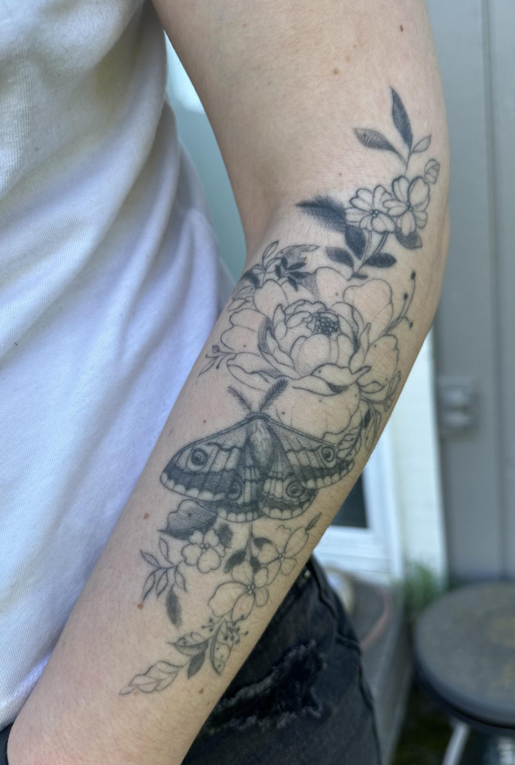 Elegant Floral and Moth Forearm Tattoo