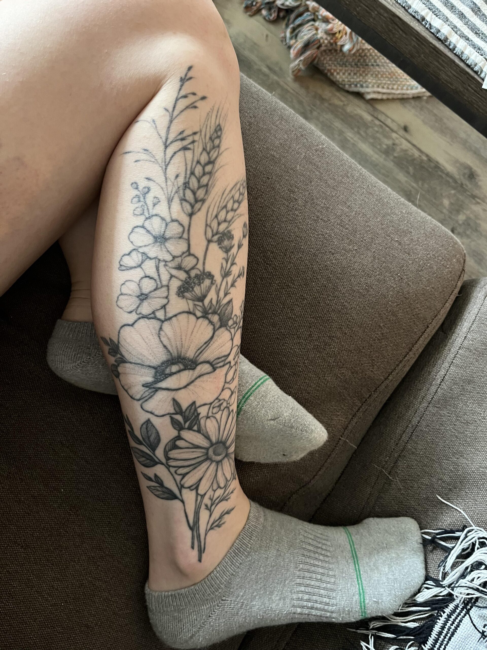 Ornate wildflower calf tattoo