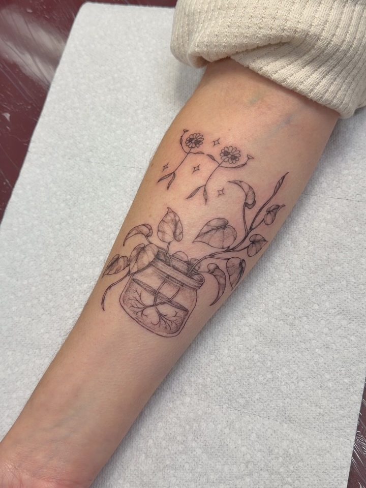 Whimsical botanical fine line tattoo