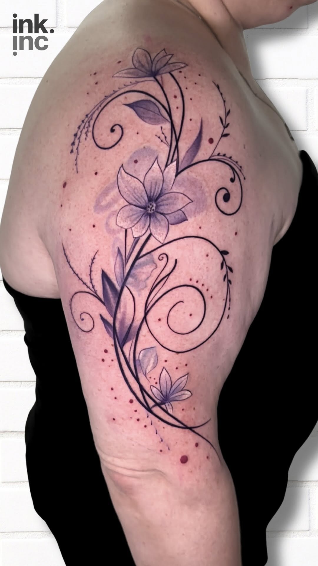 Elegant Purple Floral Arm Tattoo