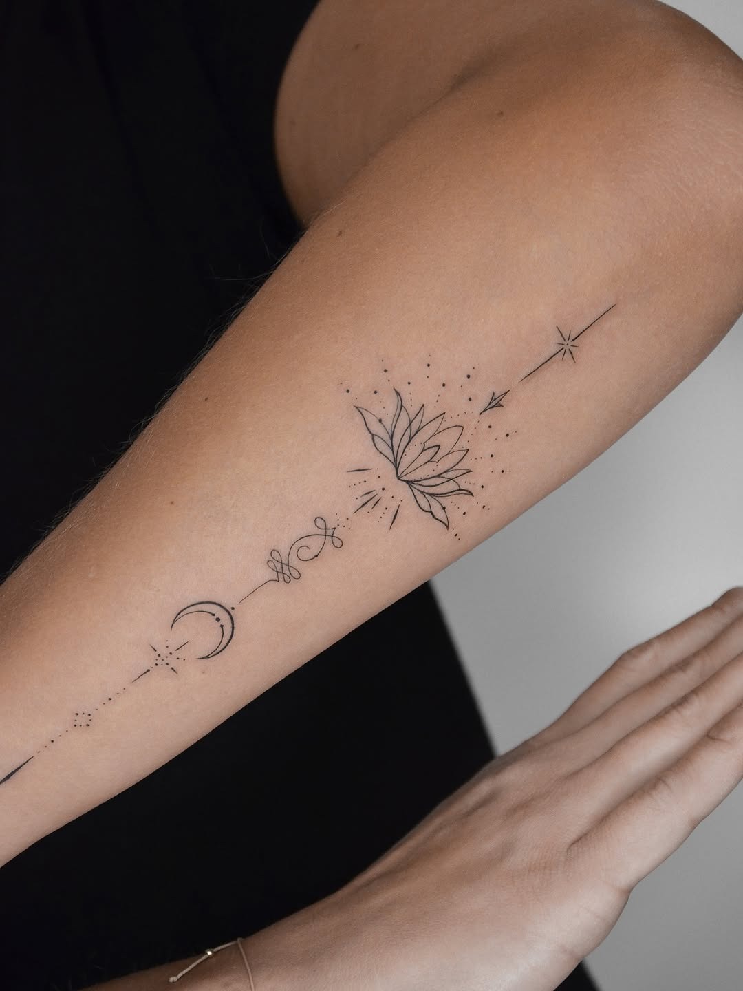 Elegant fine-line spiritual tattoo