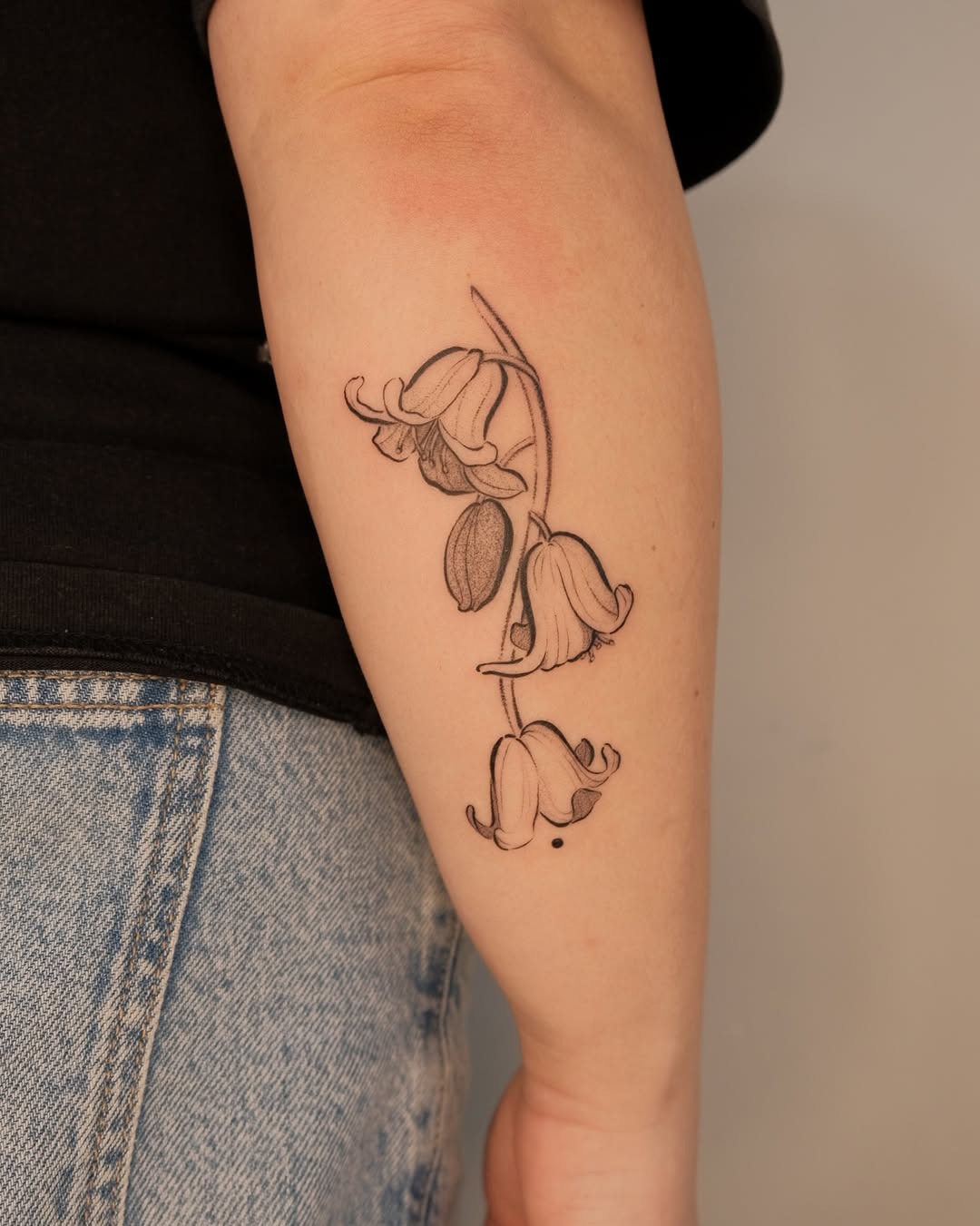 Delicate Fine-Line Lily of the Valley Arm Tattoo