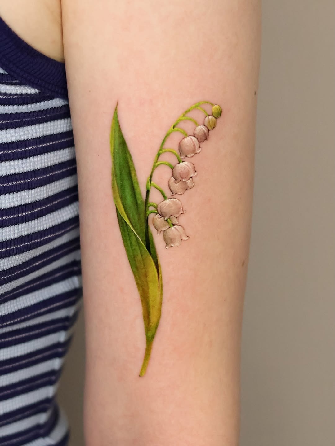 Realistic Full-Color Lily of the Valley Tattoo