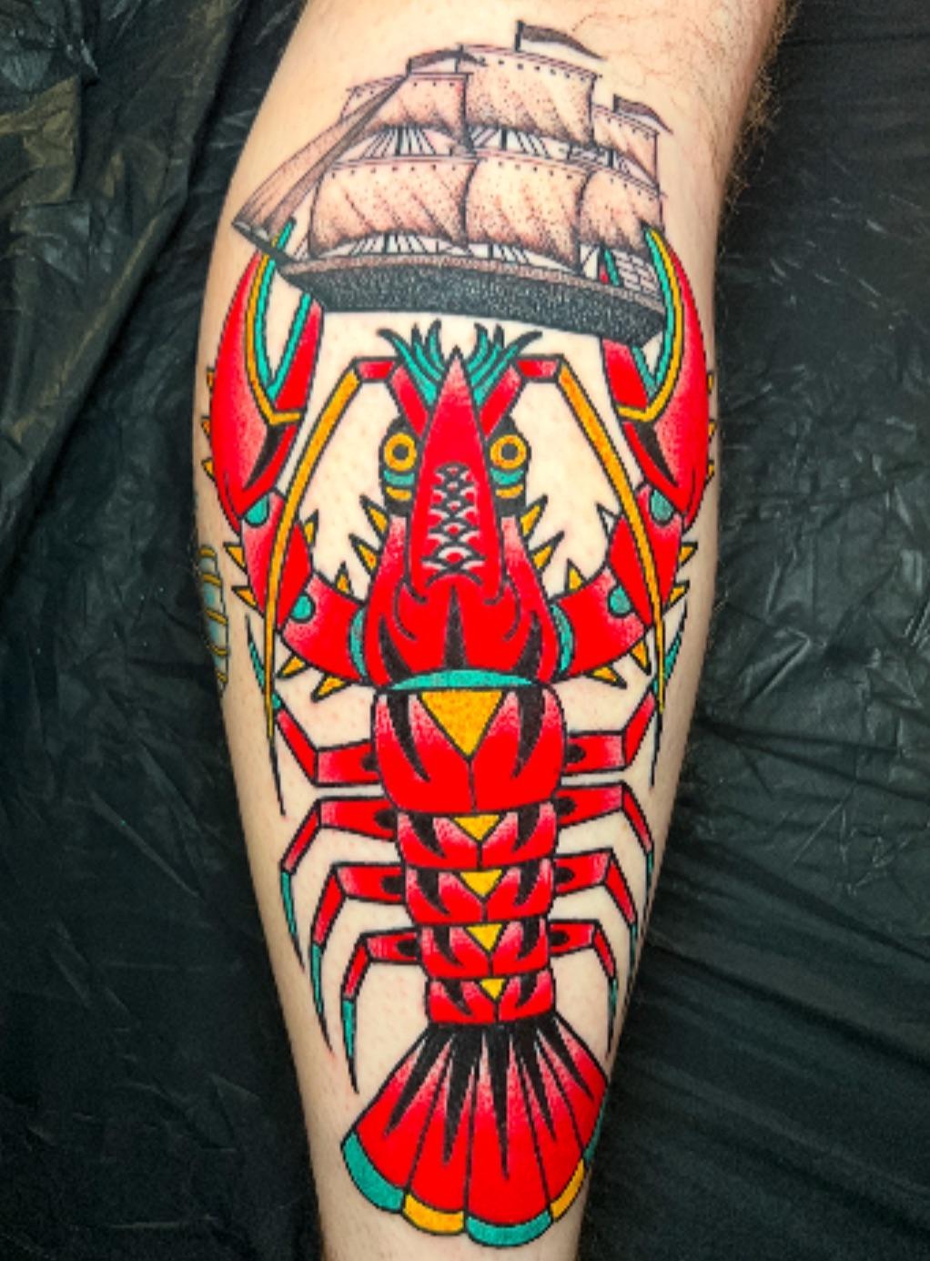 Vibrant Traditional Lobster and Ship Tattoo