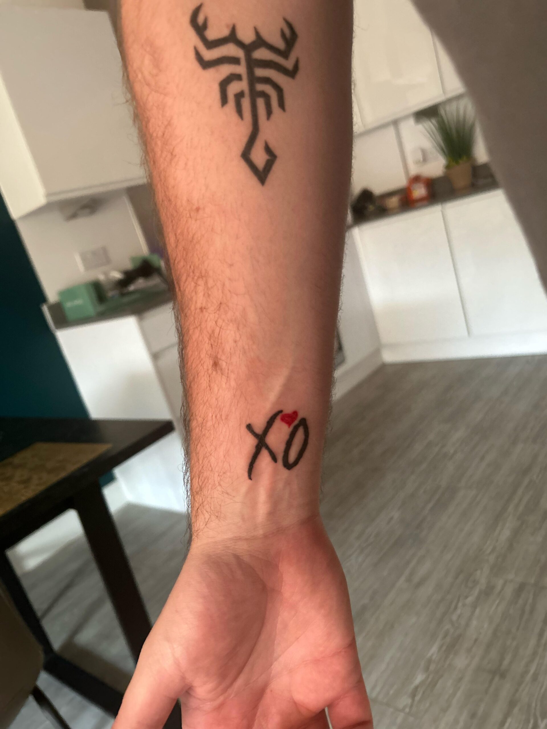 Minimalist XO wrist tattoo design
